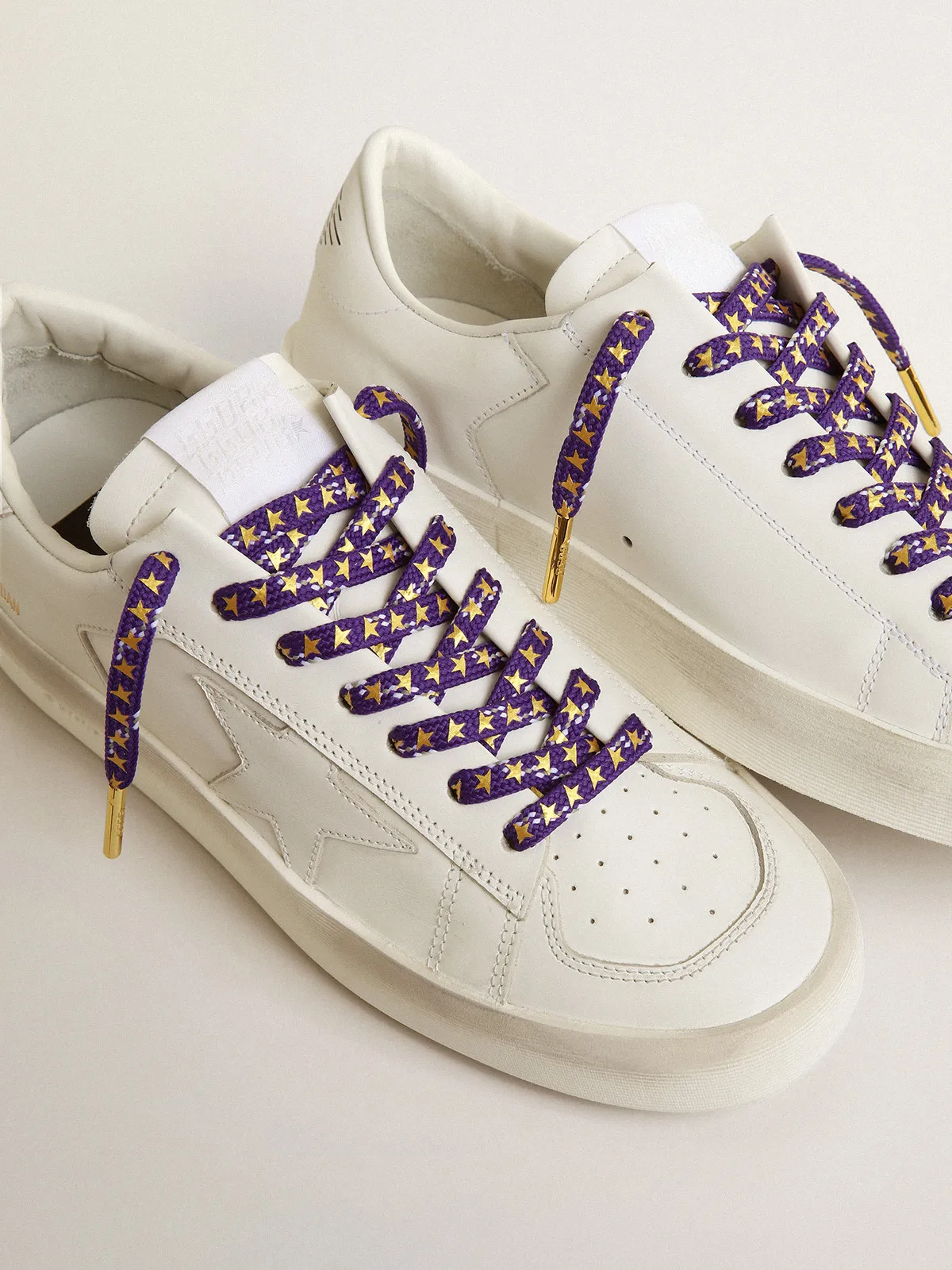 Purple laces with decorations and contrasting gold stars